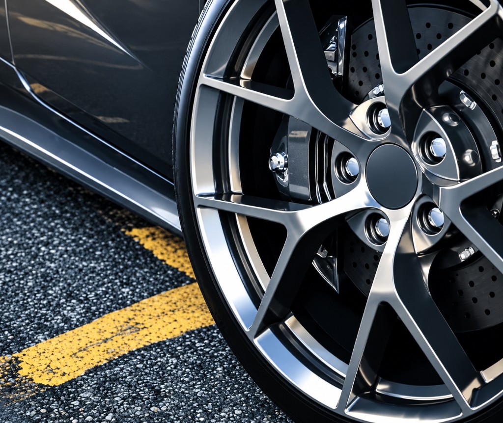 Close-up of an alloy wheel and tire on asphalt